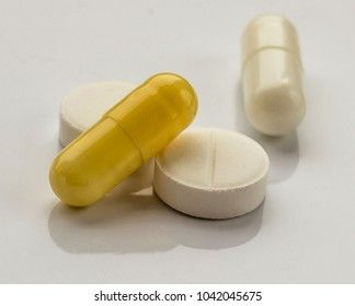 ampoules and pills on a white background