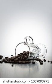 coffee beans are spilled out of an Irish glass mug on a white background