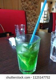 a glass of mojito in a cafe
