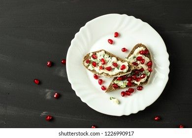 sandwich with cheese, greens and pomegranate berries 