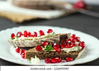 sandwich with cheese, greens and pomegranate berries 