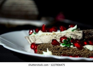 sandwich with cheese, greens and pomegranate berries 