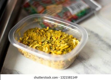 Spices for pilaf in a plastic container.