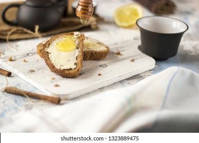 Pieces of bread with butter and honey