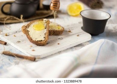 Pieces of bread with butter and honey