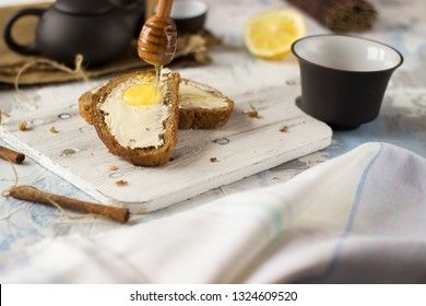 Pieces of bread with butter and honey