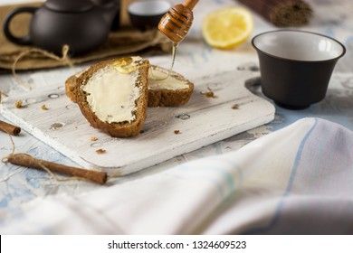 Pieces of bread with butter and honey