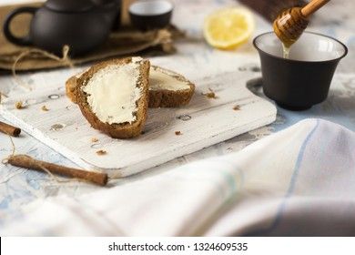 Pieces of bread with butter and honey