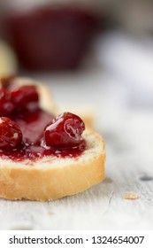 Bread with homemade cherry jam on a light background, closeup