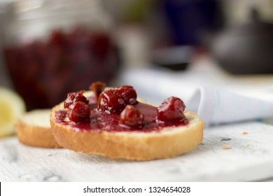 Bread with homemade cherry jam on a light background, closeup