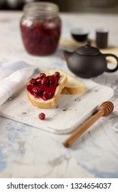Bread with homemade cherry jam on a light background, closeup
