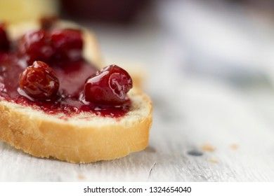 Bread with homemade cherry jam on a light background, closeup