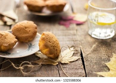 Sweet cupcakes on old wooden background.