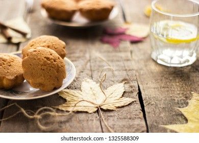 Sweet cupcakes on old wooden background.