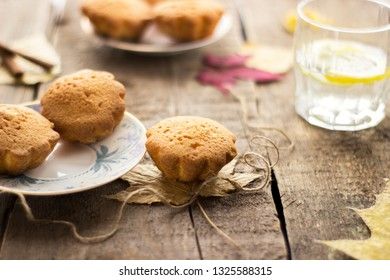 Sweet cupcakes on old wooden background.