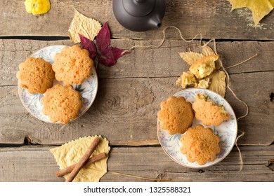 Sweet cupcakes on old wooden background. Top view.
