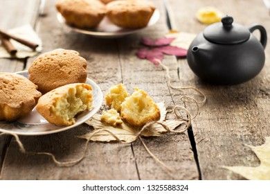 Sweet cupcakes on old wooden background.