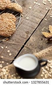 Oatmeal cookies with milk on tray on rustic wooden table