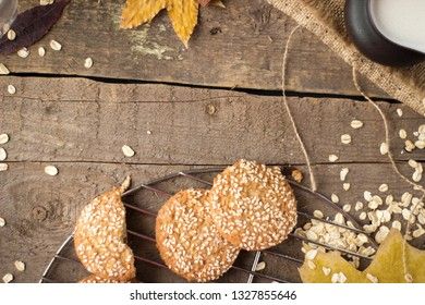 Oatmeal cookies with milk on tray on rustic wooden table. Top view.
