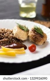Chicken cutlets with buckwheat, herbs, ketchup and tomatoes