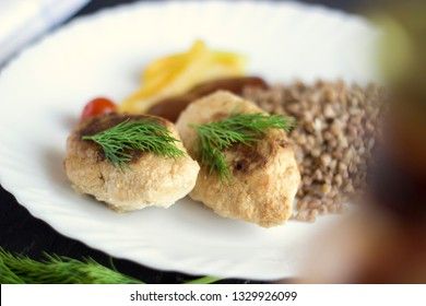 Chicken cutlets with buckwheat, herbs, ketchup and tomatoes