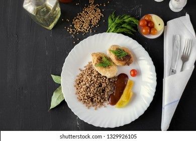 Chicken cutlets with buckwheat, herbs, ketchup and tomatoes