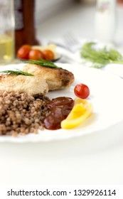 Chicken cutlets with buckwheat, herbs, ketchup and tomatoes