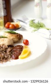 Chicken cutlets with buckwheat, herbs, ketchup and tomatoes