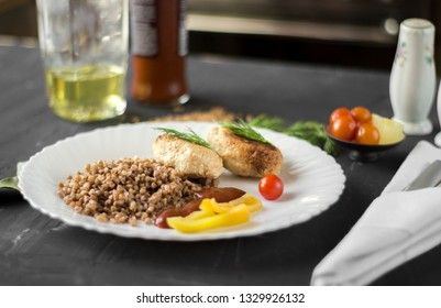 Chicken cutlets with buckwheat, herbs, ketchup and tomatoes