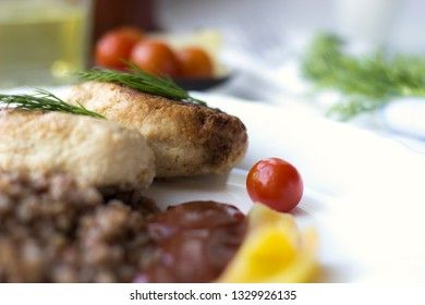 Chicken cutlets with buckwheat, herbs, ketchup and tomatoes