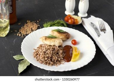 Chicken cutlets with buckwheat, herbs, ketchup and tomatoes