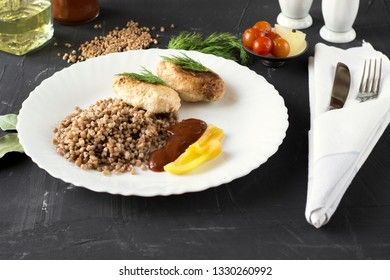 Chicken cutlets with buckwheat, herbs, ketchup and tomatoes