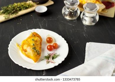 Baked chicken breast with onions and tomatoes on a white plate. Healthy food.