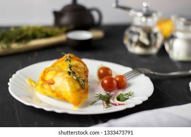 Baked chicken breast with onions and tomatoes on a white plate. Healthy food.