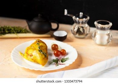 Baked chicken breast with onions and tomatoes on a white plate. Healthy food.