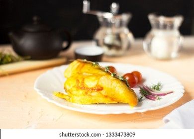 Baked chicken breast with onions and tomatoes on a white plate. Healthy food.