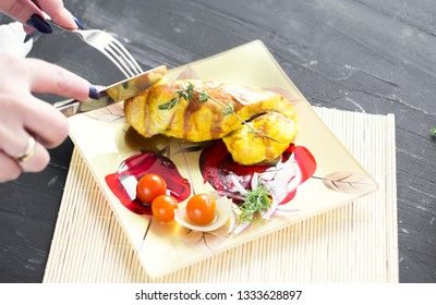 Baked chicken breast with onions and tomatoes on a white plate. Healthy food.