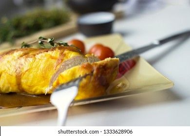 Baked chicken breast with onions and tomatoes on a white plate. Healthy food.