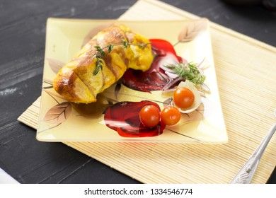 Baked chicken breast with onions and tomatoes on a white plate. Healthy food.