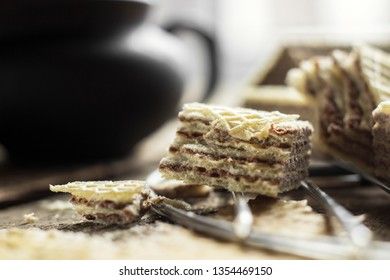Sweet russian artek waffles on wooden background, with a pot of milk. Traditional sweets and dessert.