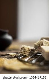 Sweet russian artek waffles on wooden background, with a pot of milk. Traditional sweets and dessert.