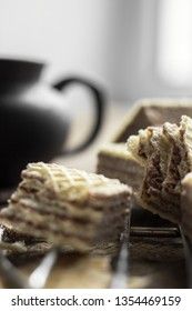 Sweet russian artek waffles on wooden background, with a pot of milk. Traditional sweets and dessert.
