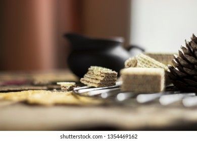 Sweet russian artek waffles on wooden background, with a pot of milk. Traditional sweets and dessert.