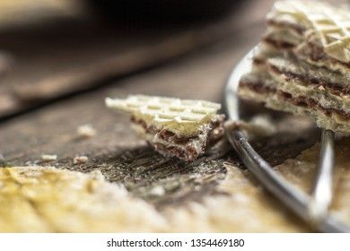 Sweet russian artek waffles on wooden background, with a pot of milk, macro. Traditional sweets and dessert.