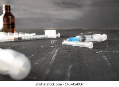 Medical ampoules with vaccine and syringe on gray background. Medical ampoules with pure vaccine and syringe on gray background