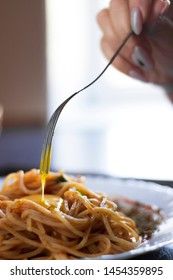 Delicious pasta with egg yolk, on wooden table.