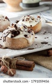 original cinnabon rolls with chocolate-cream sauce and hazelnuts