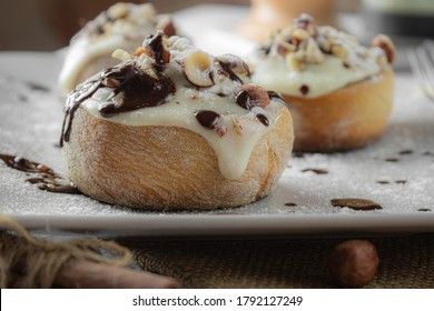 original cinnabon rolls with chocolate-cream sauce and hazelnuts