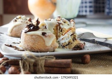 original cinnabon rolls with chocolate-cream sauce and hazelnuts