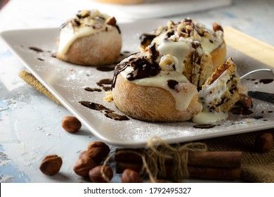 original cinnabon rolls with chocolate-cream sauce and hazelnuts